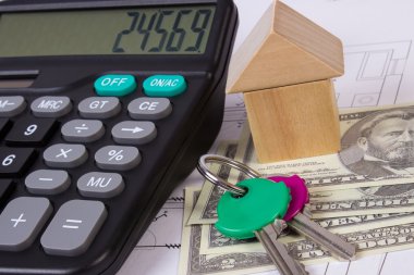 Ev ahşap bloklar ve para birimlerinin dolar çizim, ev kavramı bina inşaat hesap makinesiyle