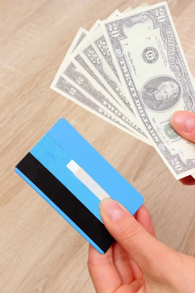 Currencies dollar and credit card in hand, finance concept — ストック写真