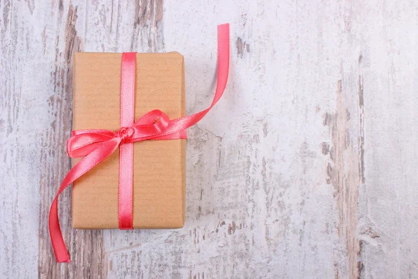 Wrapped gift for Valentines day on old wooden table, copy space for text — ストック写真