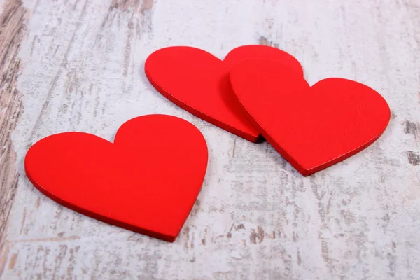 Valentine red hearts on old wooden white table, symbol of love — ストック写真