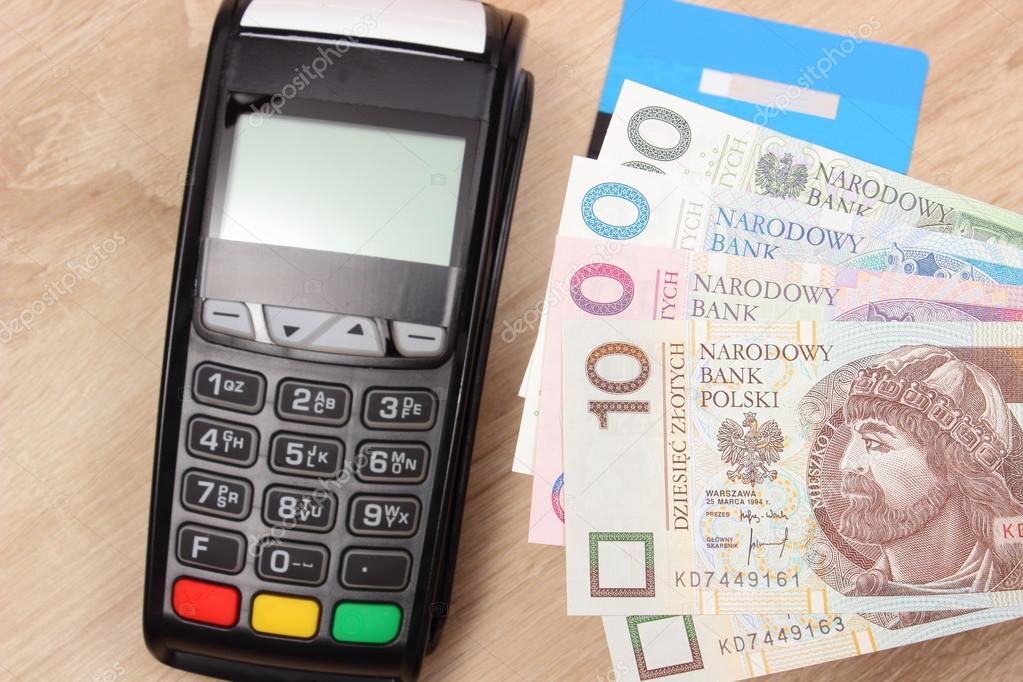 Polish currency money and credit card with payment terminal in background, finance concept