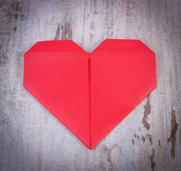 Red heart of paper on old wooden white table, symbol of love — Stok fotoğraf