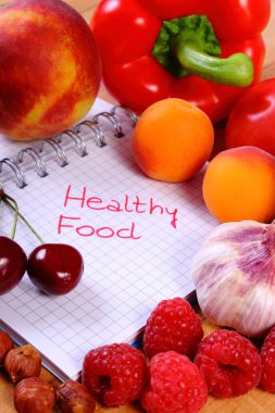 Fruits and vegetables with notebook, slimming and healthy food