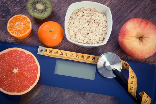 Vintage photo, Electronic bathroom scale, centimeter and stethoscope, healthy food, slimming and healthy lifestyles concept — Stok fotoğraf