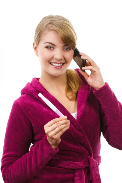 Happy woman with phone informing someone about positive pregnancy test Royalty Free Stock Images