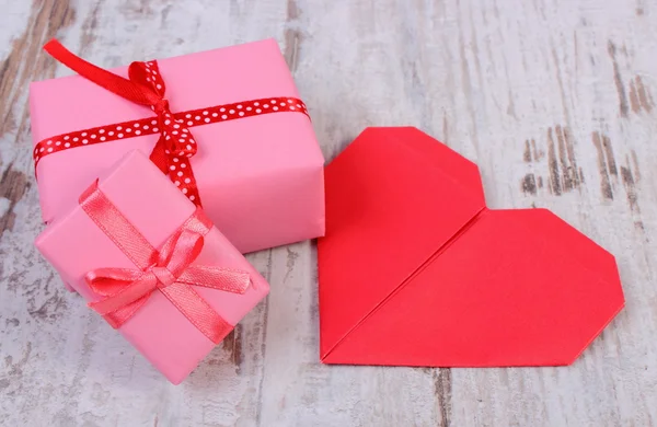 Wrapped gifts for birthday, valentine or other celebration and red heart — Stock Photo, Image