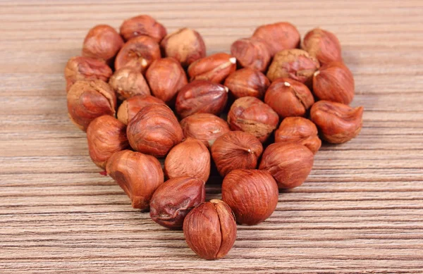 Heart of brown hazelnut on wooden table — Zdjęcie stockowe