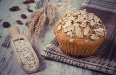 Vintage photo, Fresh muffin with oatmeal, rye flour and ears of rye grain, delicious healthy dessert