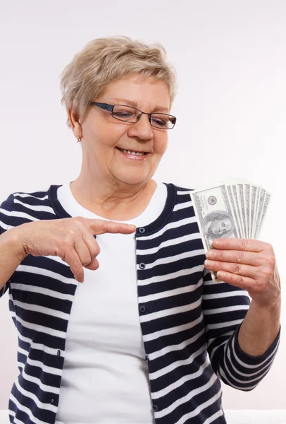Happy senior female showing currencies dollar, concept of financial security in old age — Stock Photo, Image