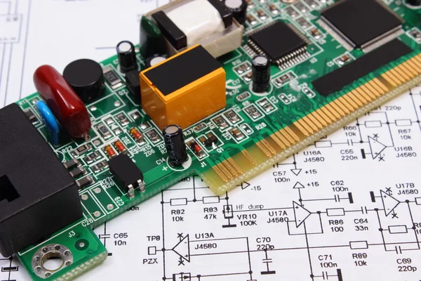 Printed circuit board lying on diagram of electronics, technology — Stock Photo, Image