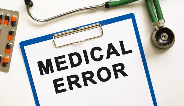 Text MEDICAL ERROR in the folder with the stethoscope. Medical concept photo