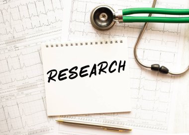 Kardiyogramlı steteskop ve yeniden arama yazılı not defteri. Sağlık hizmeti kavramı.