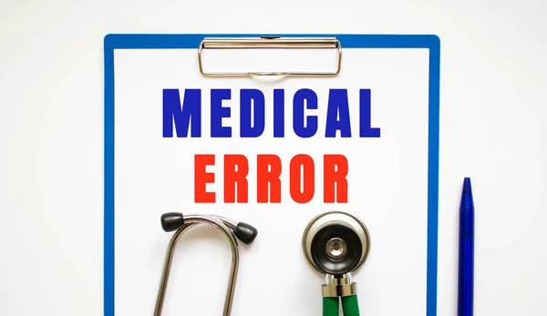 Clipboard with page and text MEDICAL ERROR, on a table with a stethoscope and pen. medical concept.