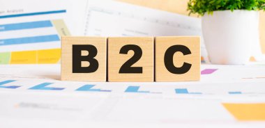 Tahta küplerle ilgili B2C kelimesi. Arka plan bir iş grafikleri. Finans kavramı