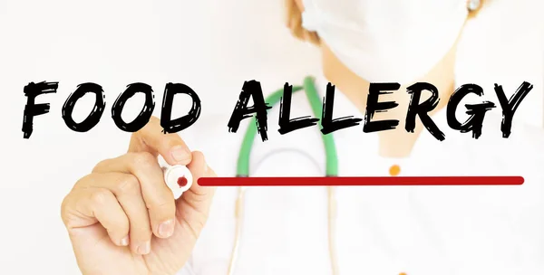 The doctor writes the text FOOD ALLERGY with a marker. Medical.