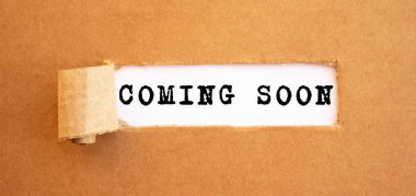 Text COMING SOON appearing behind torn brown paper. For your design, concept. clipart