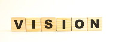 VISION kelimesi. Beyaz arka planda harflerle izole edilmiş tahta küpler. Kavramsal resim.