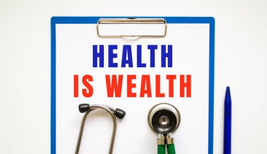 Sayfa ve metin şifresi olan pano steteskop ve kalemle dolu bir masanın üzerinde. tıbbi konsept.