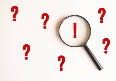 Soluk bej arkaplanda ünlem işareti olan bir büyüteç. Ünlem işaretiyle büyüteç. Yukarıdan görüntüle.