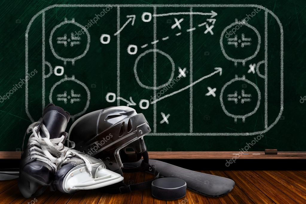 Ice Hockey Equipment and Chalk Board Play Strategy Stock Photo by