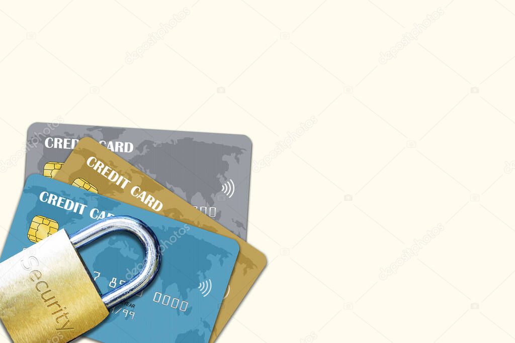Stack of multiple credit cards with security lock on top isolated with copy space. Concept of credit security over fraud, scam, phishing, theft and other white collar crimes.
