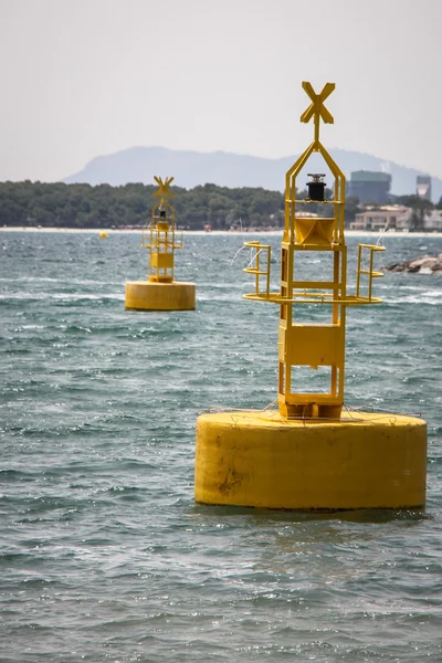 Yellow buoys and sailor boat — Stock Photo, Image