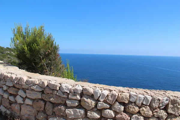 Stenen muur langs de kust — Stockfoto