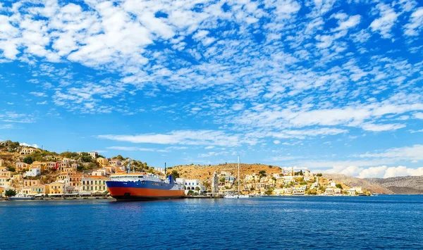 greek passenger sea ferry of Dodekanisos regular maritime traffic in bay of Simi island at the background of hills and blue sky