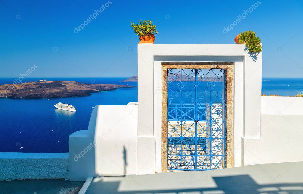 Traditional blue door on Santorini Island, Greece, with view over volcanic caldera