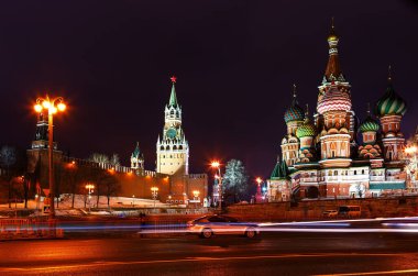 Moscow Kremlin night. St. Basil's Cathedral and Spasskaya tower on the background of the traces of car headlights