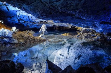 the slope of the mountain with the reflection in the water inside a fantastic cave. Kungur In The Urals