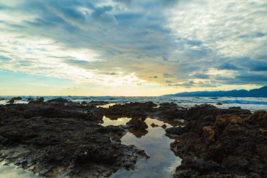 Sunset with clouds and sea waves, Crete, Greece
