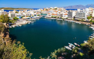 Panorama of Agios Nikolaos or Ayios, Aghios town in Crete, Greece. Showing famous places: Lake, Marina, Bay