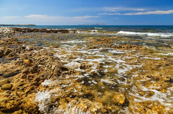 Rocks on the shore of the sea near Gouves, Crete, Greece.