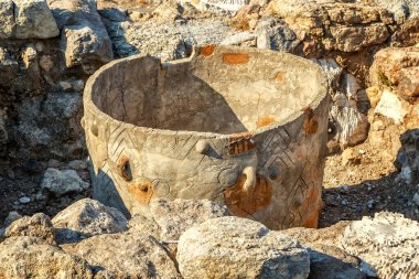ancient ancient pot storage among the stones of the ruins clipart