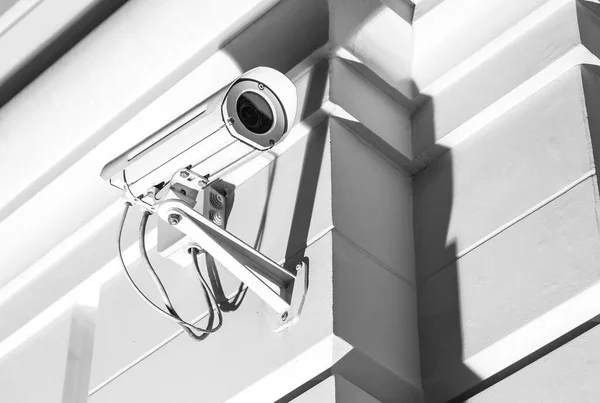 CCTV security camera for home protection, privacy, security against crime & surveillance, mounted on house exterior wall.