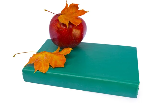 Apple with book and dry leaves — Stock Photo, Image