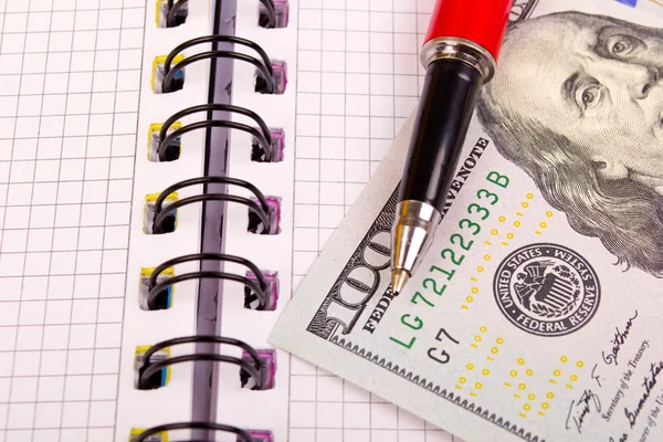 Pen and dollars are on the notebook — Stock Photo, Image