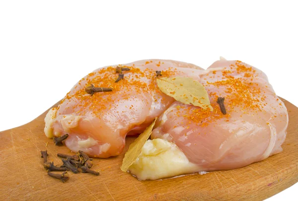 Fresh chicken meat with spices on a wooden — Stock Photo, Image