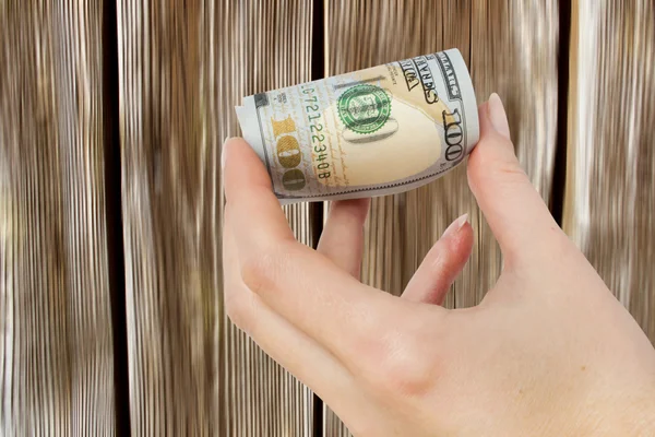 Hold in your hand the money on a wooden background, — Stock Photo, Image