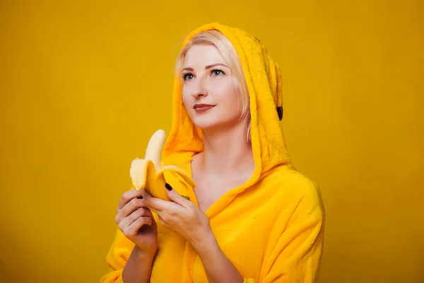Girl Yellow Clothes Yellow Background Eats Banana Woman Pajama Party — Stock Photo, Image