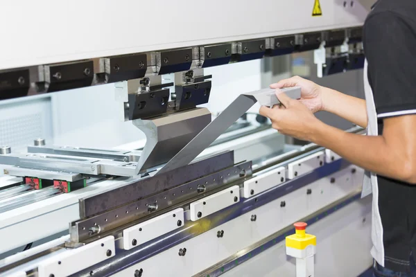 Operator bending metal sheet by sheet bending machine — Stock Photo, Image