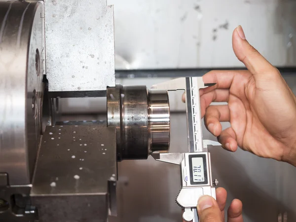 Operator machining mold and die part by CNC turning machine in f — Stock Photo, Image