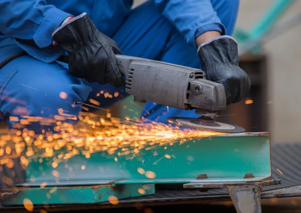 Arbeiter schleifen Stahl mit der elektrischen Schleifmaschine — Stockfoto