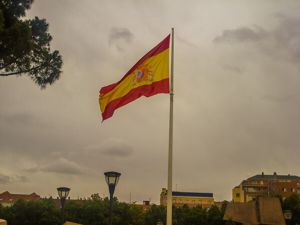 Flag of Spain against blue sky. 