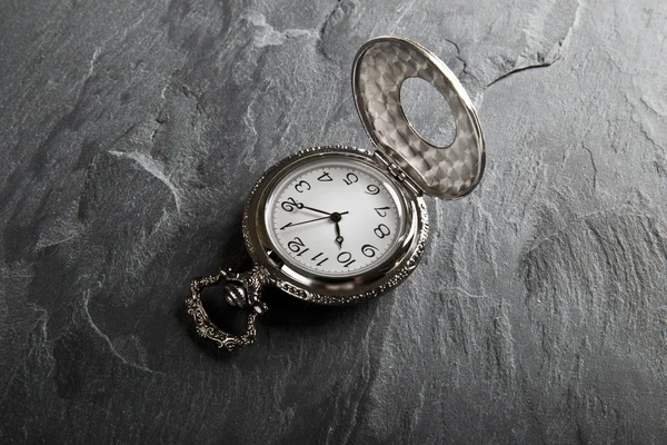 Pocket gray clock on dark gray — Stock Photo, Image