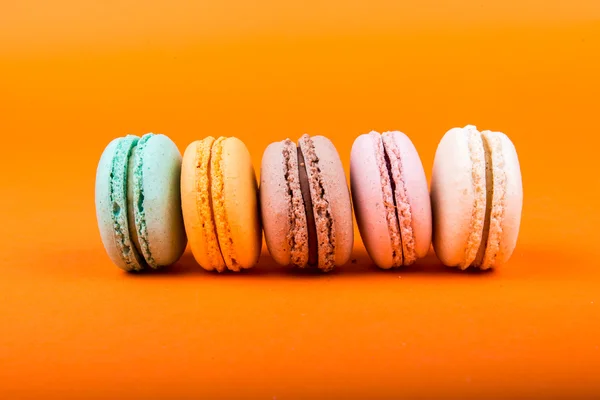 Set of macarons on orange background — Stock Photo, Image