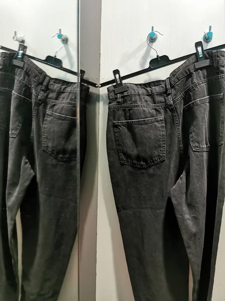 Schwarze Zerlumpte Jeans Auf Kleiderständern Der Garderobe — Stockfoto