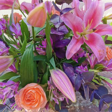 Beautiful summer flowers in the basket. Flowers basket on the street
