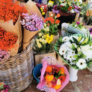 Beautiful summer flowers in the basket. Flowers basket on the street Flower market.